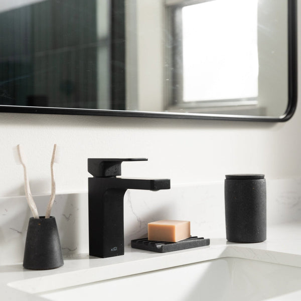 Black concrete bath accessories at a sink