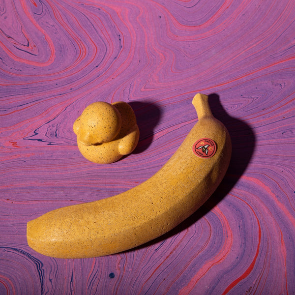 Concrete Banana on marbled purple backdrop