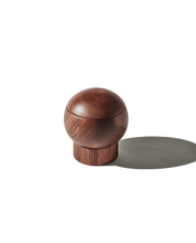 The Salt Sphere salt cellar in Walnut wood, from Material — magnetic swivel lid and fluted stackable base.